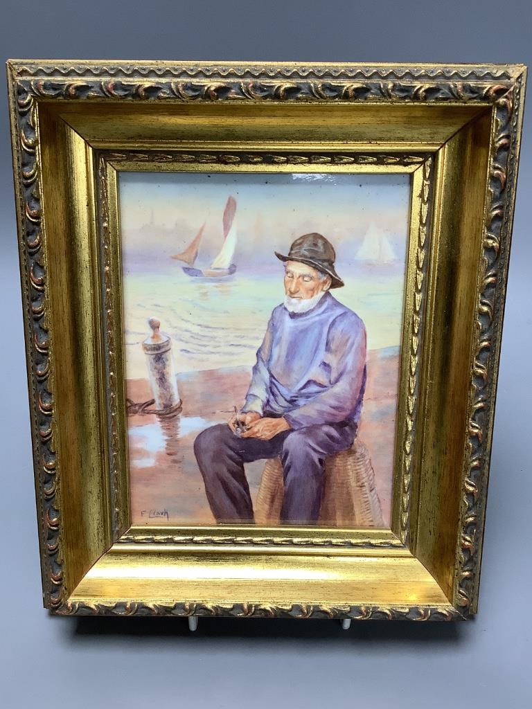 A framed porcelain plaque painted by Francis Clark, depicting a fisherman smoking his pipe 17.5x13cm excl frame